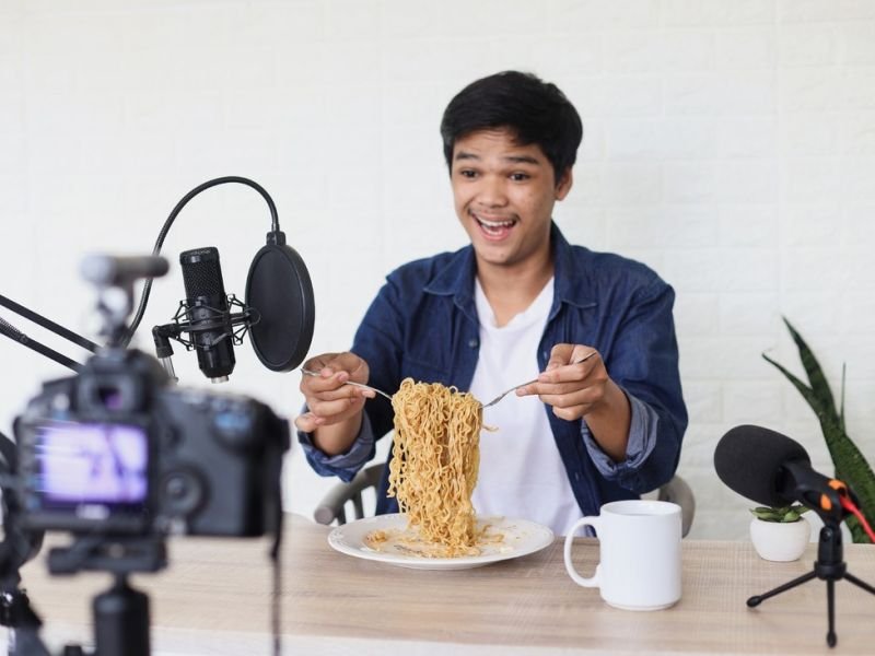 A Photo of Mukbang https://competes.tv/wp-content/uploads/2023/08/Mukbang-Food-Challenge-Trend-Mukbang-Competes-TV-food-reviews-viral-eating-videos-culinary-challenges-Cooking-Competitions-food-challenge-eating-show-Online-Trends-24670b74.jpg