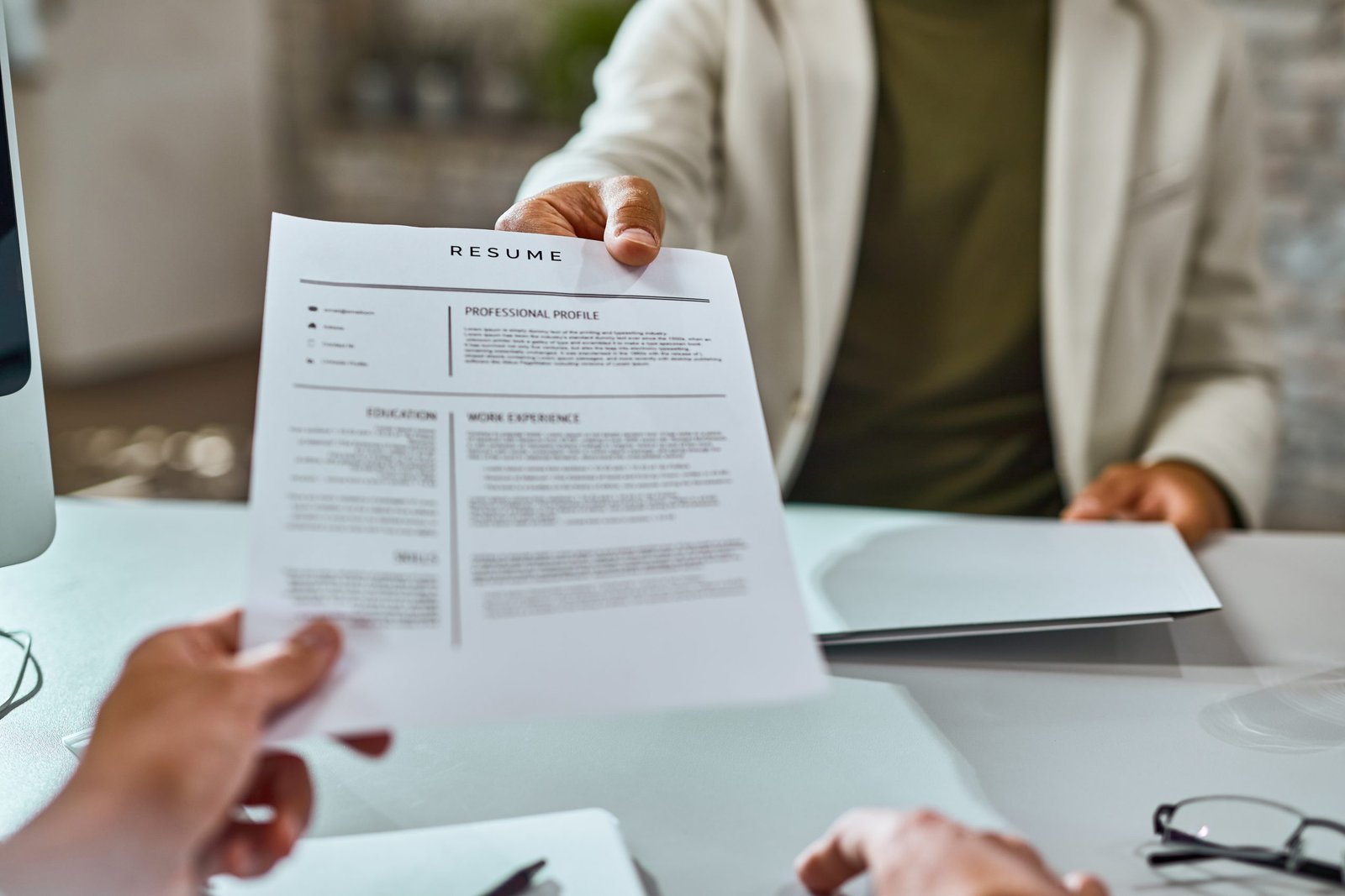 Close Up Of Candidate Giving His Cv On A Job Interview.
